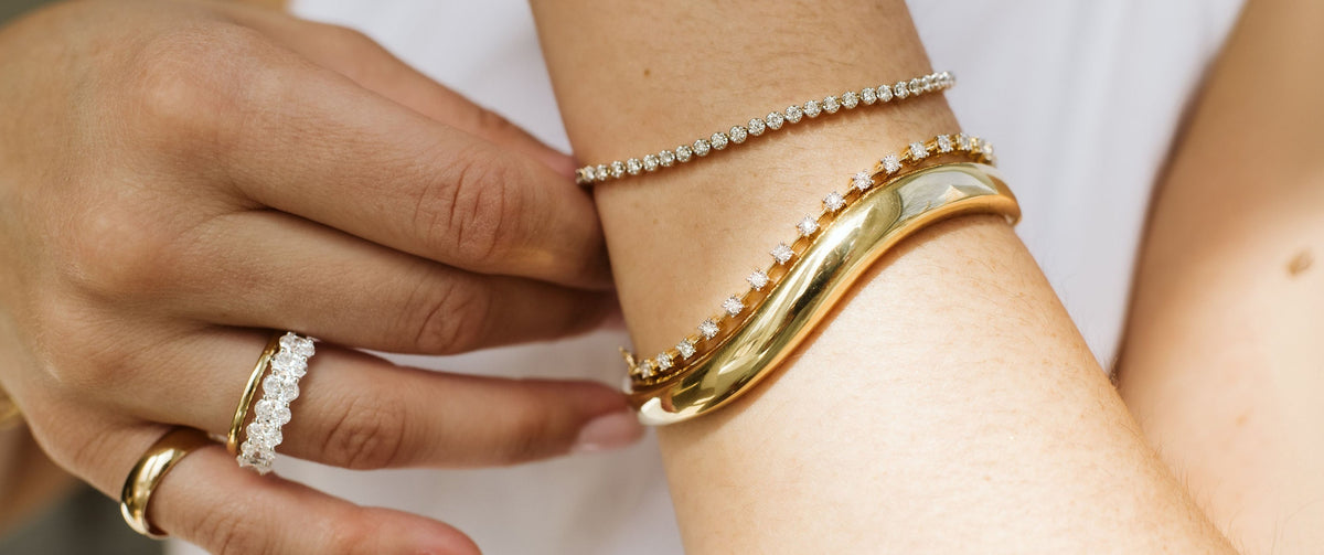 Close Up on Gold Bangle and Tennis Bracelets