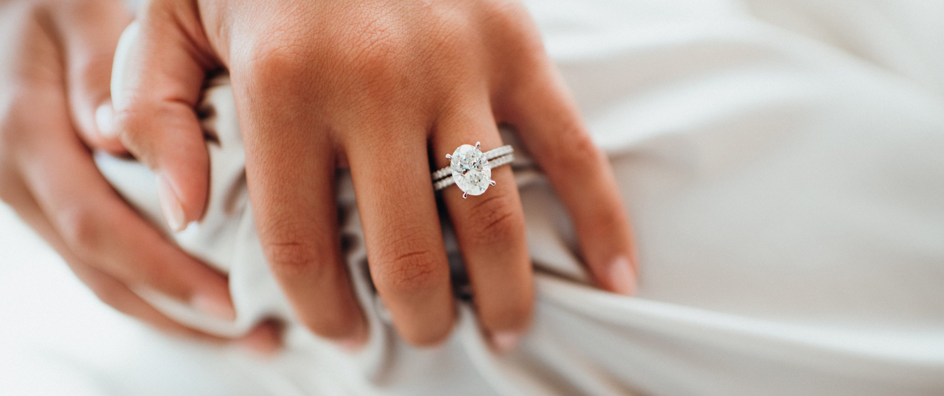 Close up on oval diamond engagement ring.