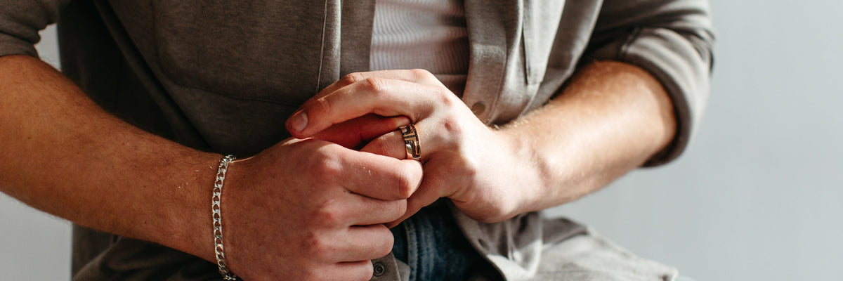 Men Photography playing with wedding band on his finger.