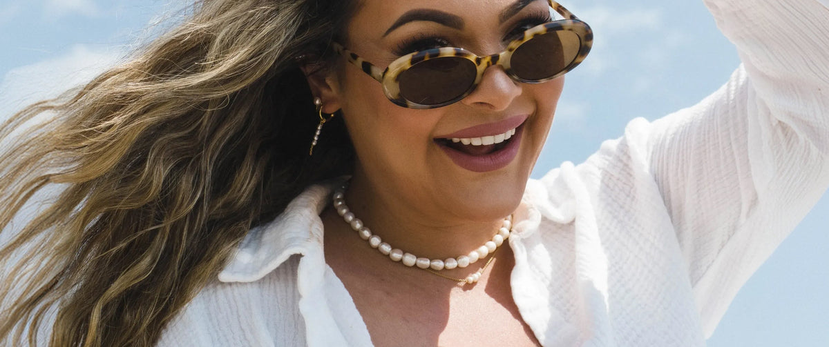 Woman wearing pearl necklaces, earrings and rings