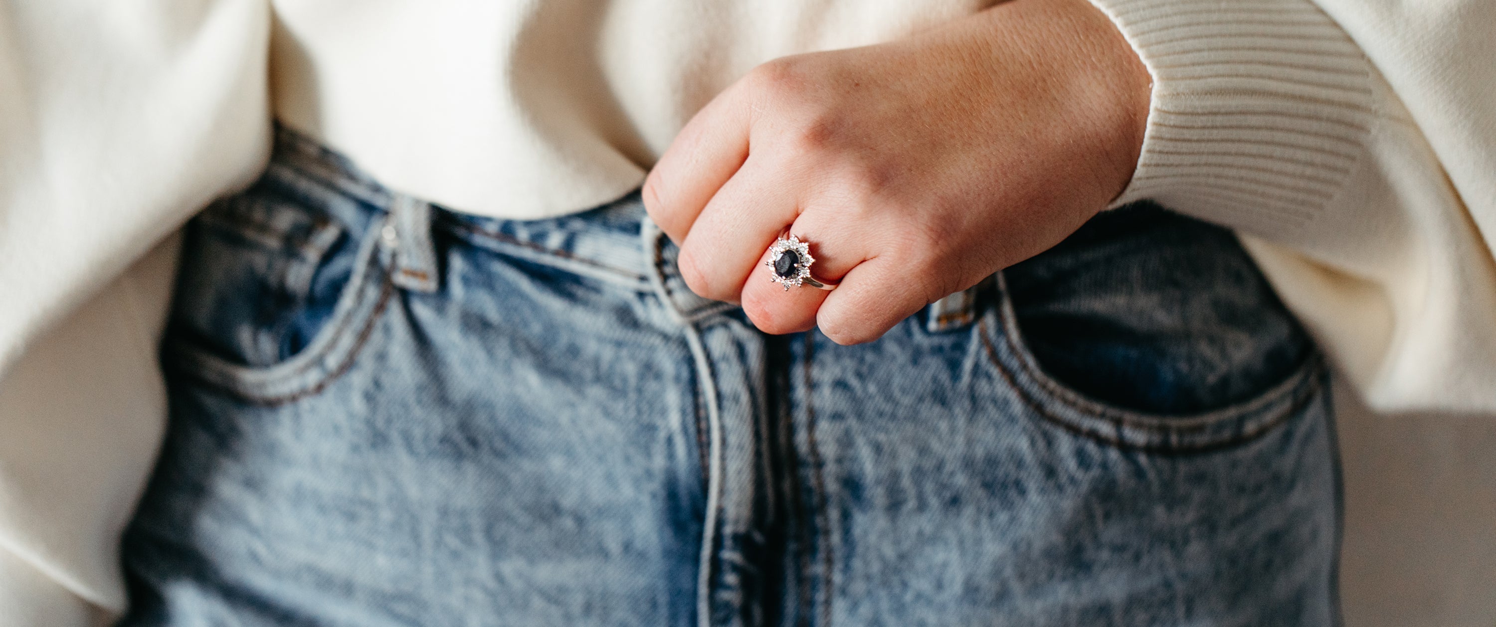 Woman wearing a blue sapphire and diamond engagement ring