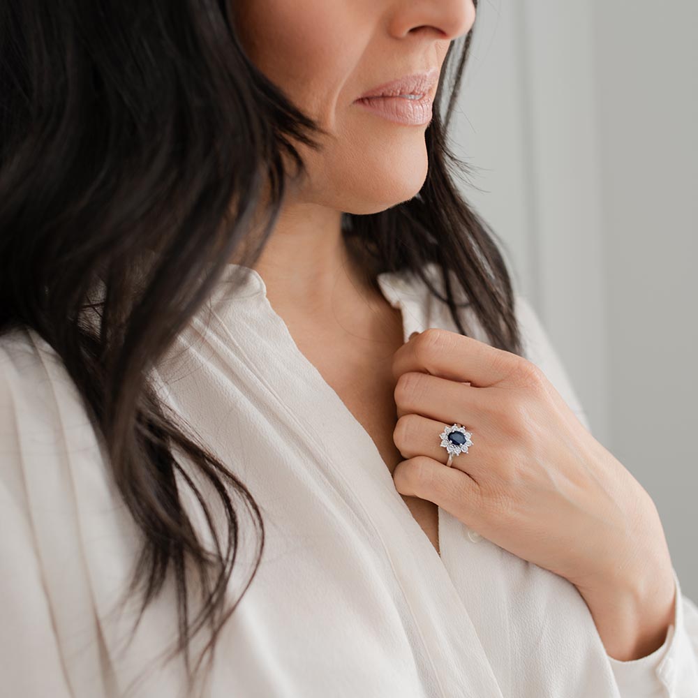 Oval Halo Ring with Blue Sapphire and .18 Carat TW of Diamonds in 10kt White Gold