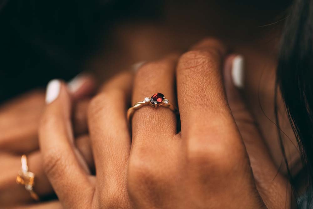 Ring with 4X6MM Oval Garnet and .06 Carat TW of Diamonds in 10kt Yellow Gold