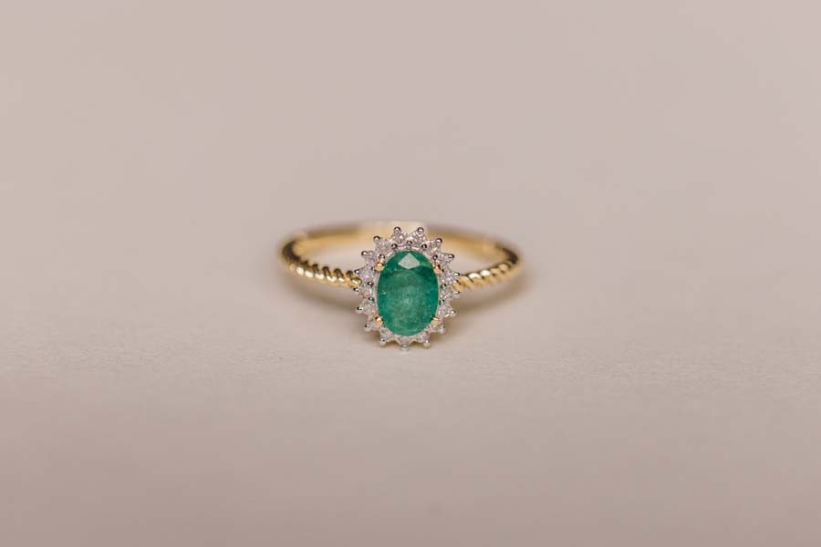 Halo Ring with .13 Carat TW of Diamonds and 7x5MM Oval Emerald in 10kt Yellow Gold
