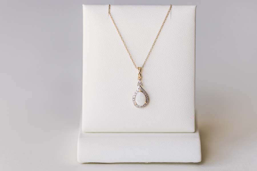 Halo Pendant with .13 Carat TW of Diamonds and 7x5MM Pear Shape Opal in 10kt Yellow Gold with Chain