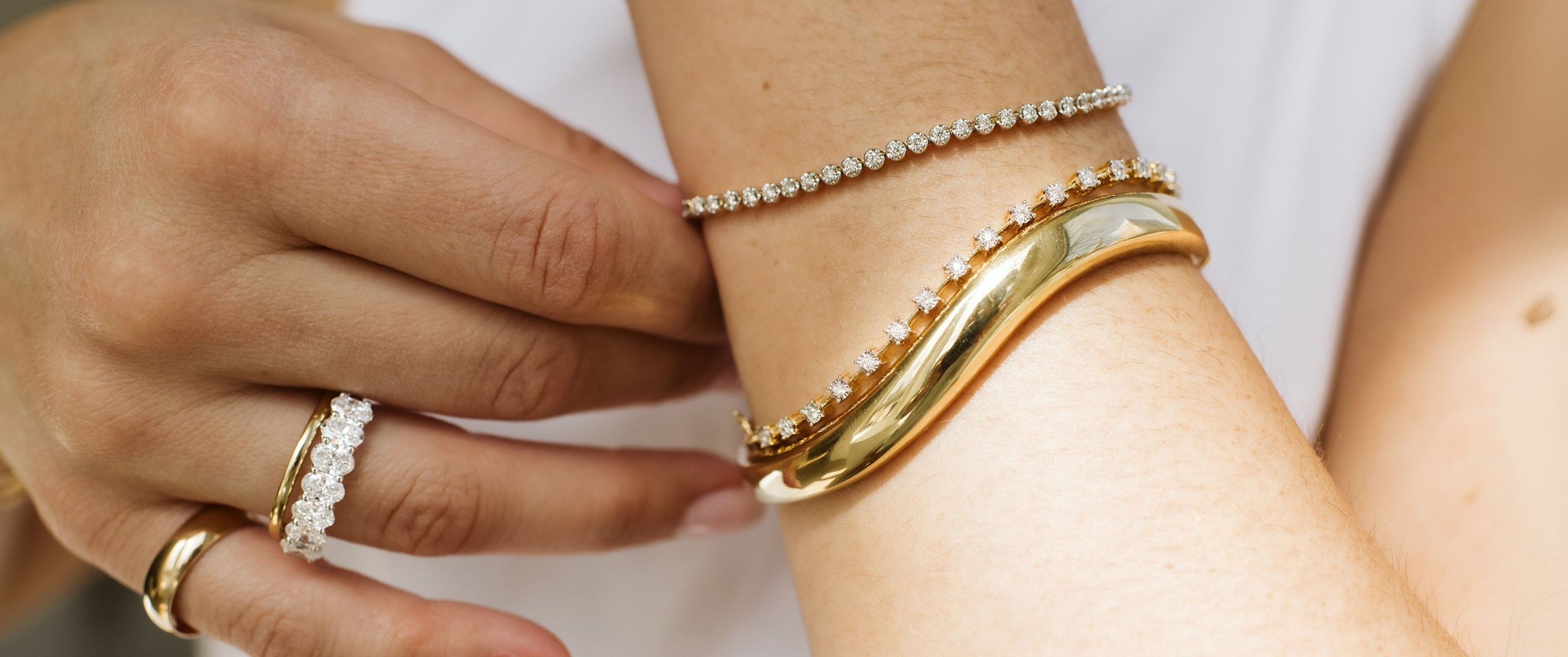 Close Up on Gold Bangle and Tennis Bracelets