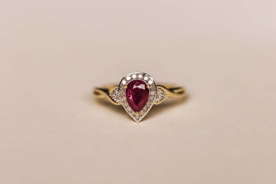 Halo Ring with .17 Carat TW of Diamonds and 7x5MM Pear Shape Ruby in 10kt Yellow Gold