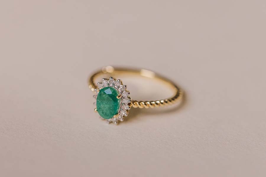 Halo Ring with .13 Carat TW of Diamonds and 7x5MM Oval Emerald in 10kt Yellow Gold