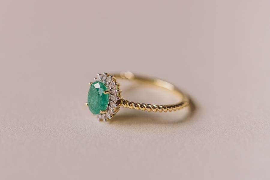 Halo Ring with .13 Carat TW of Diamonds and 7x5MM Oval Emerald in 10kt Yellow Gold
