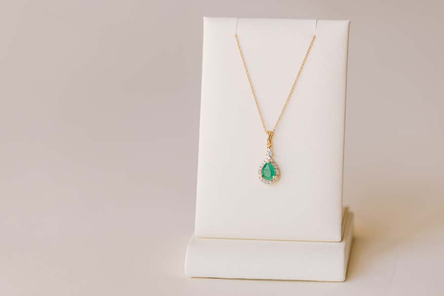 Halo Pendant with .13 Carat TW of Diamonds and 7x5MM Pear Shape Emerald in 10kt Yellow Gold with Chain
