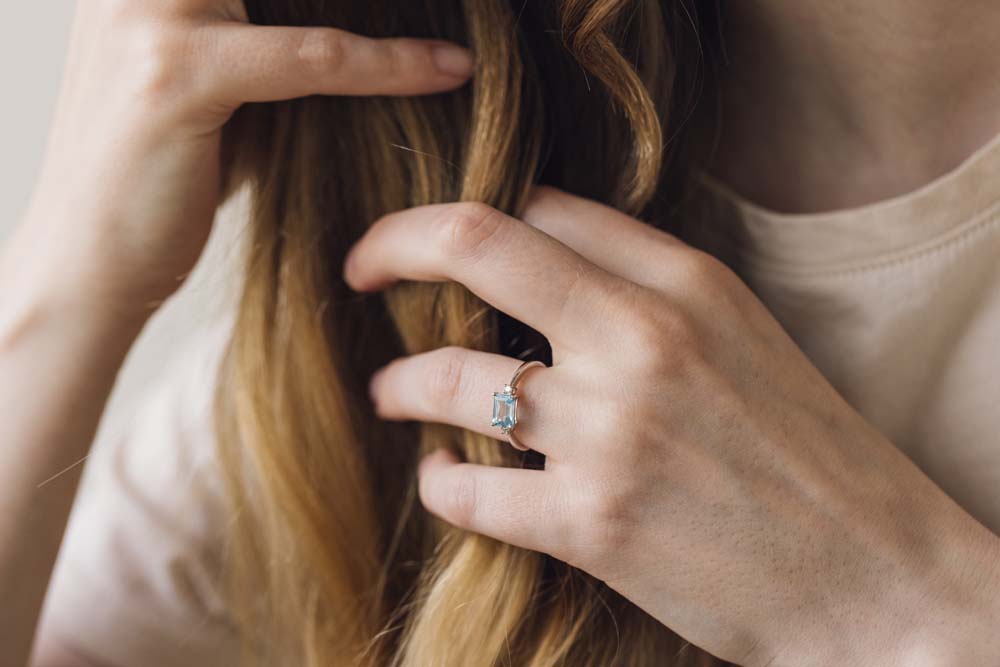 Emerald Cut Blue Topaz Ring with .07 Carat TW of Diamonds in 10kt White Gold