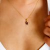 Pendant with .06 Carat TW of Diamonds and Oval Garnet in 10kt Yellow Gold with Chain