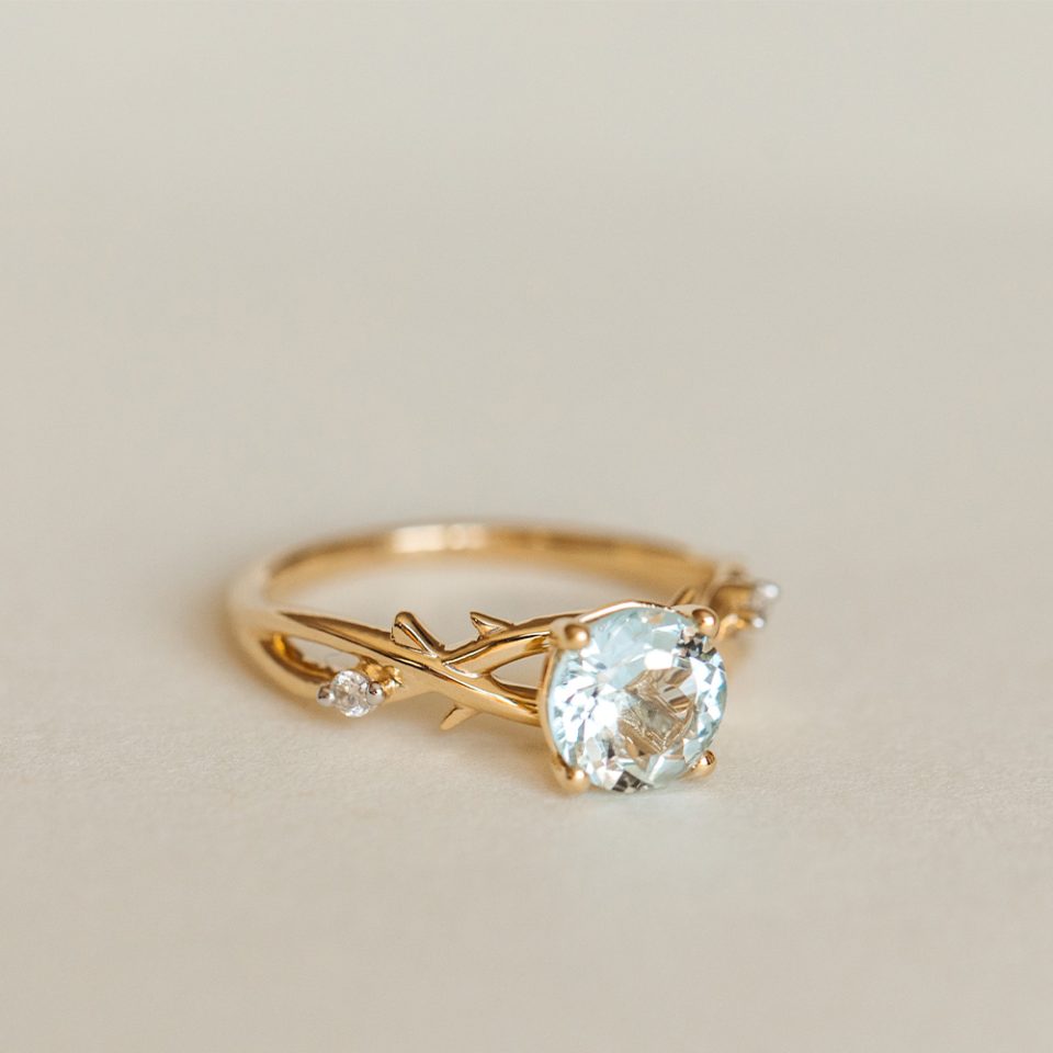 Ring With 7MM Round Aquamarine And .04 Carat TW Of Diamonds In 14kt Yellow Gold